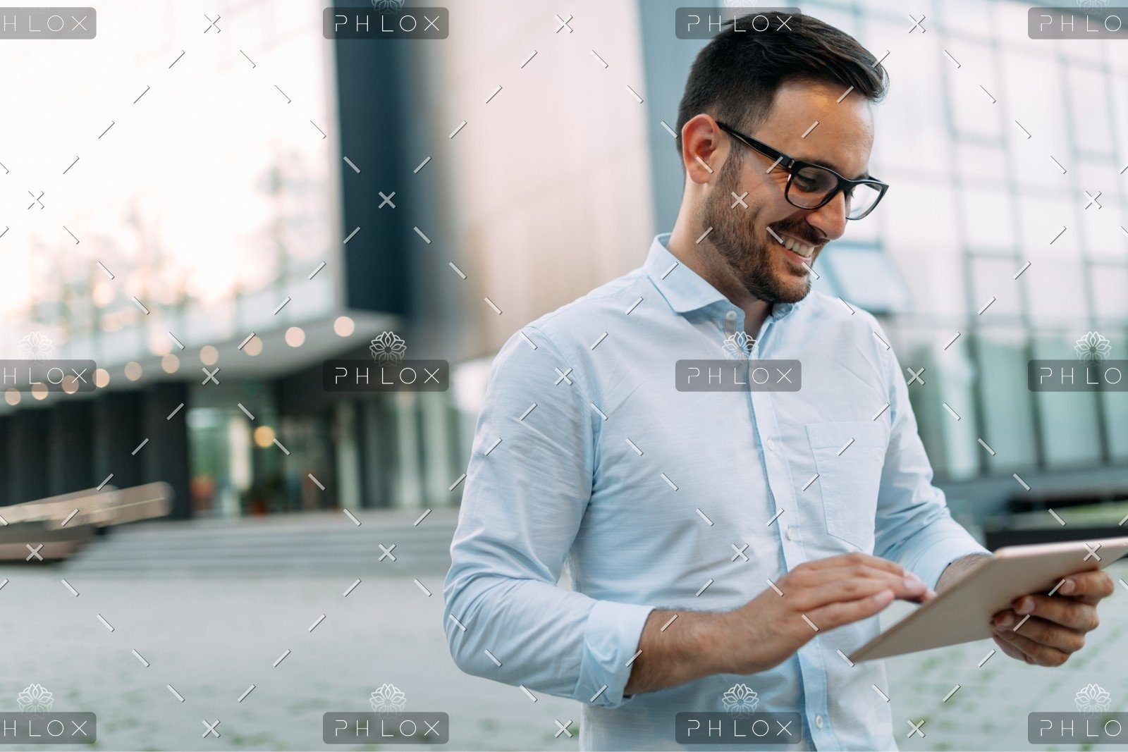 demo-attachment-508-portrait-of-businessman-in-glasses-holding-tablet-AWVHCJU